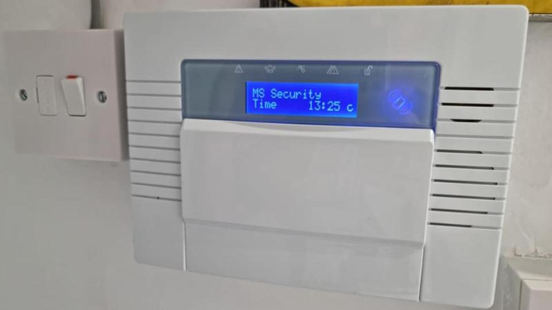 A modern alarm panel upgraded by MS Security Systems, showing the MS Security name on the display