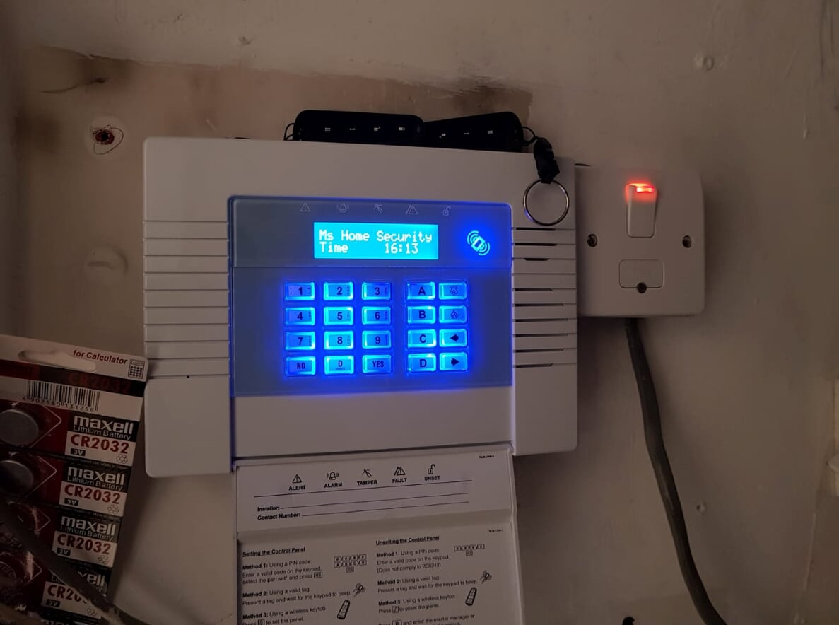 An MS Home Security branded alarm keypad, lit up and ready to use
